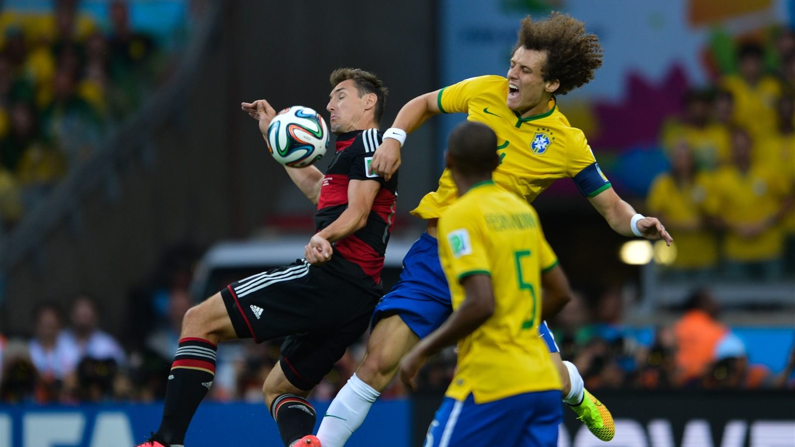 David Luiz challenges Miroslav Klose in the air during Brazil 1–7 Germany at the Mineirão in the 2014 World Cup