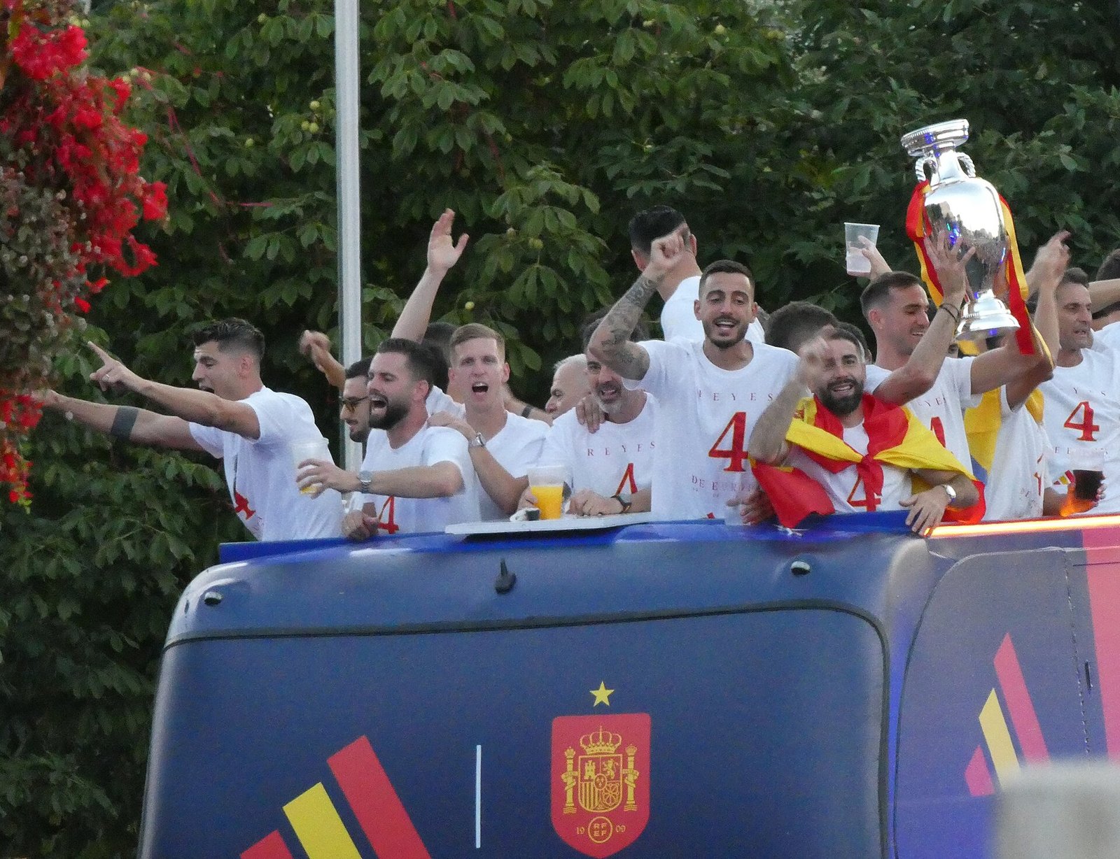 Spain national team players celebrate with the trophy on an open-top bus during a title parade in Madrid