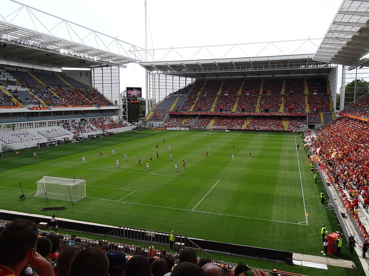 The Stade Bollaert-Delelis in Lens during a match, with the home end in red and yellow